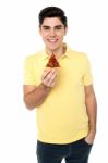 Casual Boy Posing With Pizza Slice Stock Photo