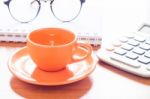 Close Up Of Coffee Cup With Book And Eyeglasses Stock Photo