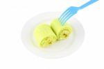 Green Sweet Roll Cake On Dish And Blue Fork Stock Photo