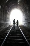 Couple Walking Together Through A Railway Tunnel Stock Photo