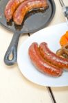 Beef Sausages Cooked On Iron Skillet Stock Photo