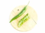 Green Chili Pepper Sliced With Raw Material On Cutting Board Stock Photo