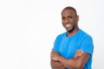 Casual Man Standing With Crossed Arms Stock Photo