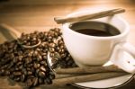 Coffee Cup And Coffee Beans On Old Wooden Background Stock Photo