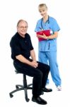 Pleasing Doctor Collecting Patient's Health History Stock Photo