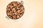 Coffee Roasted Bean In The Bucket On Wooden Background Stock Photo