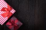 One Gift Box With An Red Big Ribbon On Old Wooden Dark Brown Bac Stock Photo