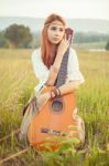 Hippie Girl Playing Guitar On Grass Stock Photo