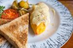 Omelet With Potato, Tomatoes Parsley And Feta Cheese And Bread In White Plate On Wooden Table Stock Photo