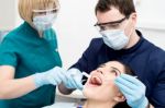 Dentist Examining Gums Of Patient Stock Photo