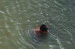 Boy Swimming In The Bharatha River Stock Photo