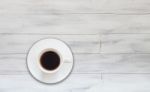 Top View Of Coffee Cup On White Wooden Background Stock Photo