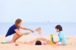 Mother And Sons Are Playing On Tropical Beach Stock Photo