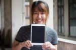 Portrait Of Thai Adult Beautiful Girl Using Her Tablet Stock Photo