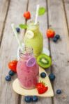 Fresh Blended Fruit Smoothies In Vintage Milk Bottles Stock Photo