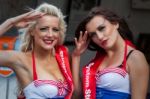 Two Smiling Ladies Saluting At The Goodwood Revival Stock Photo