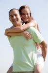 Man Carrying Woman On Back Stock Photo