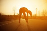 Woman Exercising Outdoor At Sunset  Stock Photo