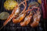 Shrimp Grilled On Barbeque Charcoal Oven With Lemon Pineapple Red Chilly And Corn Stock Photo