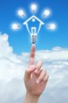 Light Bulb Model Of House In Hand Stock Photo