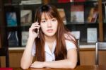 Portrait Of Thai Adult Student University Uniform Beautiful Girl Using Her Smart Phone Stock Photo