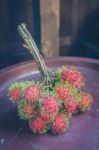 Rambutan On Wood Stock Photo