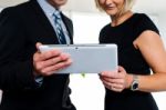 Business Colleagues Watching Videos On Tablet Stock Photo