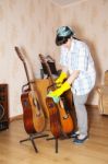 Woman Cleaning A Guitar With A Rag Stock Photo