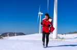 Young Woman Is A Happiness With Camera In Winter Of Sky And Winter Road With Snow And Red Dress Stock Photo