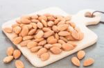 Almond Nuts On Wooden Plate Stock Photo