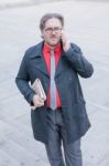 Young Businessman With A Newspaper With An Smartphone Stock Photo