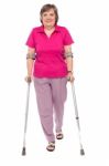 Senior Lady Walking With Crutches Stock Photo