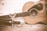 Vintage Guitar With Wine Bottle And Glass On The Old Wood Floor Stock Photo