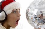 Surprised Woman Looking To Disco Ball And Wearing Christmas Hat Stock Photo