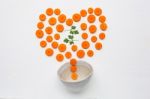 Chopped Carrot Slices Heart Shape And Parsley Leaves With Bowl Stock Photo