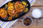 Delicious Baked Chicken Thighs With Lemon Slices, Onion And Zucchini Stock Photo