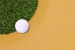 Golf Ball Edge Of Grass Field And Sand Stock Photo