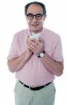 Old Man Holding Coffee Mug Stock Photo