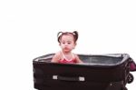 Little Girl Sitting In Suitcase Stock Photo