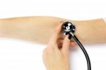 Female Hand Holding Stethoscope On Arm Of Patient Stock Photo
