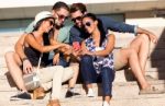 Portrait Of Group Of Friends Having Fun With Smartphones Stock Photo