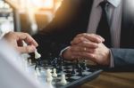 Confident Businessman Colleagues Playing Chess With Colleague To Stock Photo