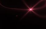 Abstract Lens Flare Light Over Black Background Stock Photo