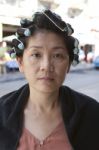 Natural Face Of Young Woman Dressing Her Hair Stock Photo