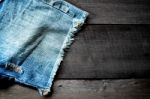 Jeans Lack On The Wooden Floor Stock Photo