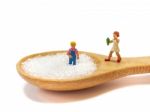 Miniature Little Children Standing On A Wooden Spoon And Thinking Of Sugar, Diet, Fat And Diabetes. Health Care Concept Stock Photo