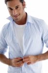 Man Tucking His Shirt Buttons Stock Photo