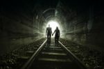 Couple Walking Together Through A Railway Tunnel Stock Photo