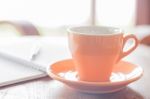 Closeup Orange Coffee Cup In Coffee Shop Stock Photo