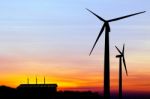 Silhouette Wind Turbine Generator With Factory Emissions Of Carb Stock Photo